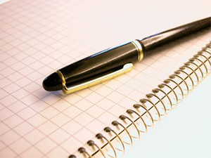 Image of pens on graph paper
